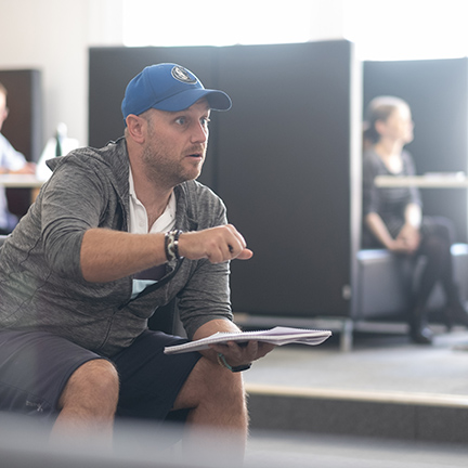 A man in converation in the communal area of Victory centre