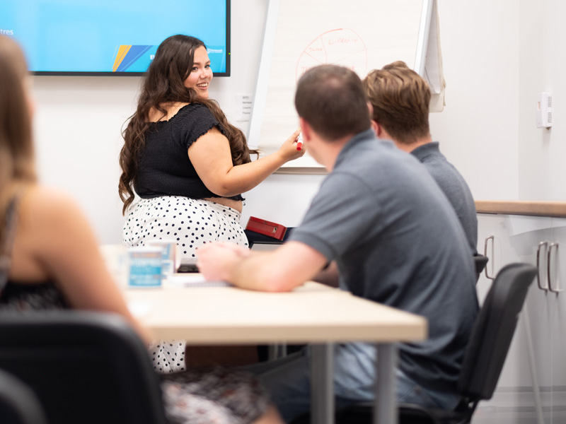 Lady hosting a meeting in a meeting room at Portsmouth EC