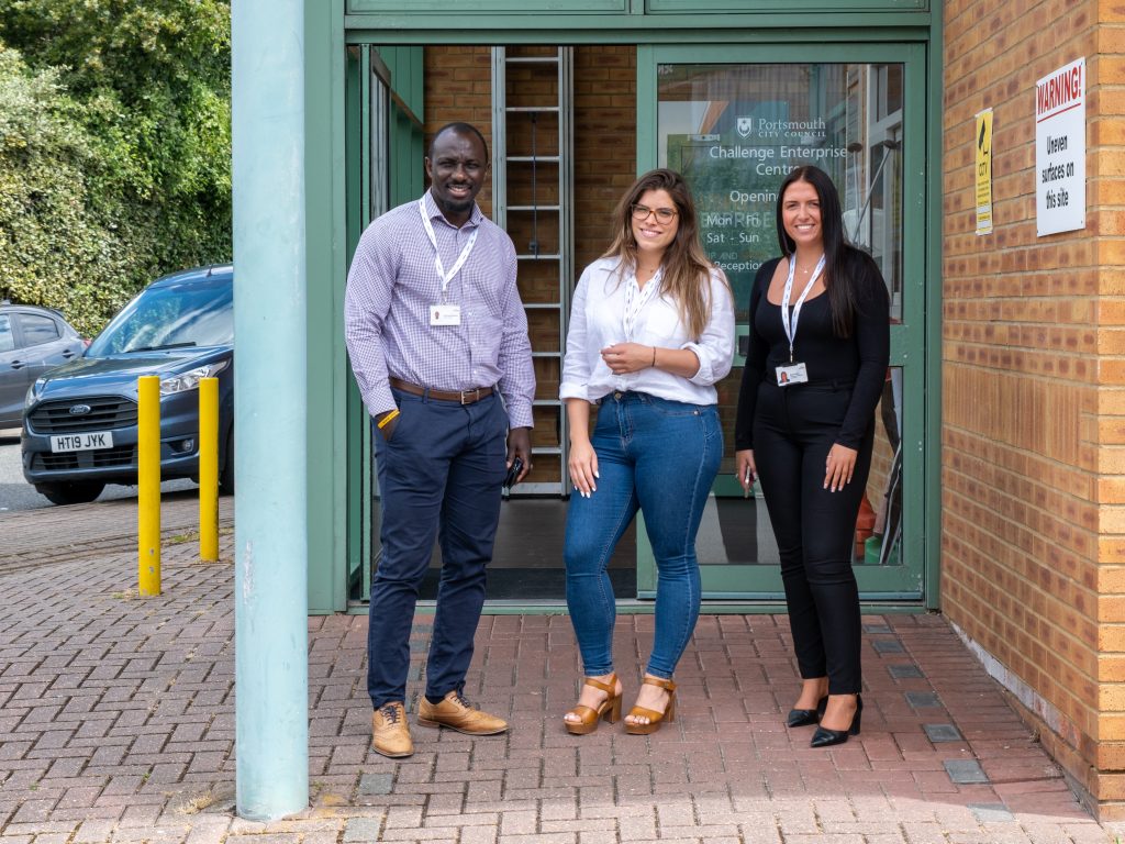 3 People standing outside the entrance to the Challenge Enterprise Centre